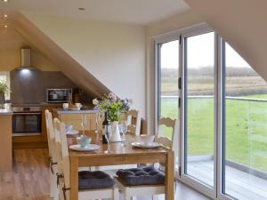 a kitchen and dining room with a table and chairs at Swift Cottage - Ukc3435 in Newton Abbot