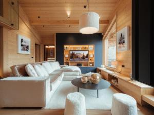 a living room with a couch and a table at Chalet La Clusaz, 7 pièces, 10 personnes - FR-1-304-282 in La Clusaz