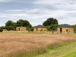 a row of houses in a field next to a fence at Rosemary in Wootton Bridge