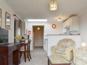 a living room with a couch and a table at The Annexe in Newchurch