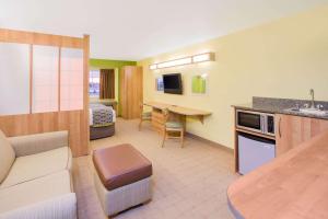 a hotel room with a kitchen and a living room at Microtel Inn & Suites by Wyndham Delphos in Delphos