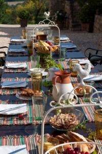 a long table with plates of food on it at Villa Montecastello in Monteriggioni