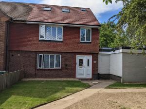 a red brick house with a white door at 32 in Ashford