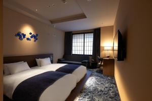 Ένα ή περισσότερα κρεβάτια σε δωμάτιο στο Minn Kanazawa