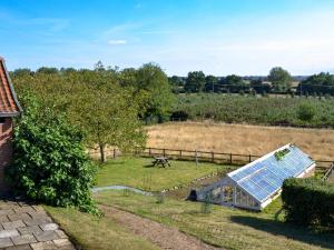 a house with a solar panel in a field at The Mill The Mill House in Ludham