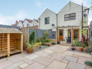 a garden with a patio and a fence at Church View in Barmby on the Marsh