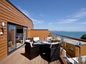 a balcony with a table and chairs on a deck at Dunlin 4 - The Cove in Brixham