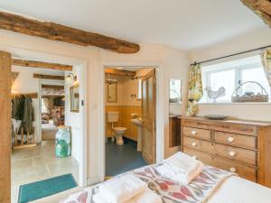 a bedroom with a bed and a bathroom at The Granary in Hawnby