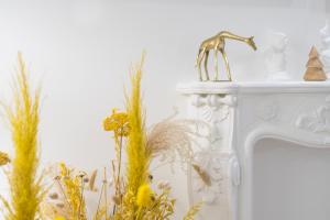 a white fireplace with a gold faucet and some plants at Brand New I Beachfront I 3 min Old Town ANVERS in San Sebastián
