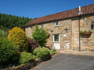 an old stone house with a driveway at The Granary in Hawnby