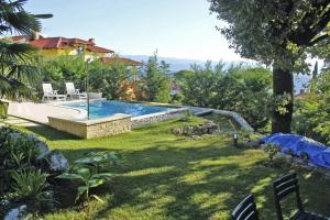 a yard with a swimming pool and a house at Bruk in Lovran - Kvarner Region in Lovran