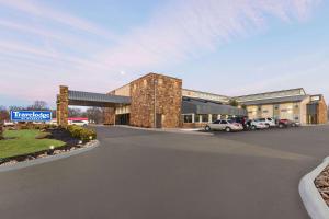 a rendering of a building with cars parked in a parking lot at Travelodge by Wyndham Coffeyville in Coffeyville
