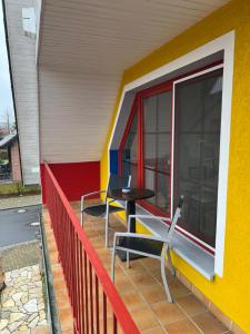 a patio with two chairs and a table on a building at Pension-Geli in Monplaisir