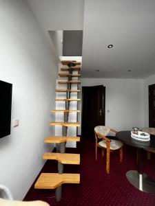 a spiral staircase in a room with a table and chairs at Pension-Geli in Monplaisir