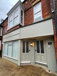 a house with two garage doors on a brick building at Kittiwake Number 4A - Town Centre Ground Floor in Bridlington