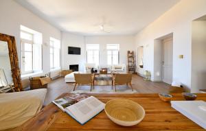 a living room with a table and a living room at Luxurious modern villa with a fantastic sea view in Ioulida