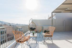 a group of chairs and a table on a balcony at WYZ Piraeus in Piraeus