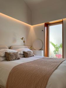 een slaapkamer met 2 bedden en een groot raam bij CASA DOS OLIVAIS in Porto
