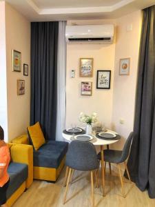 a living room with a table and a couch at GONIO Beachfront Cosy Apartment in Gonio +6 photos