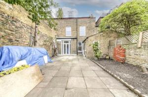 an empty street in front of a brick building at A beautiful newly renovated home: The Arlingford in London