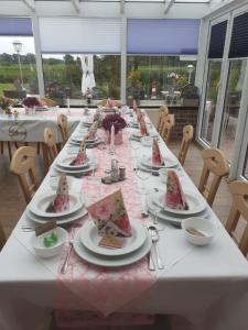 uma mesa longa com pratos de comida em Hotel Am Deich em Apen