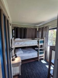 two bunk beds in a room with a window at Villa De Vie Self Catering Apartment in Brackenfell
