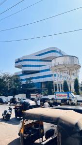 a building with a lot of traffic in front of it at Astropods in Mumbai