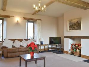 a living room with a couch and a fireplace at Foxcote New Court Farm in Marstow