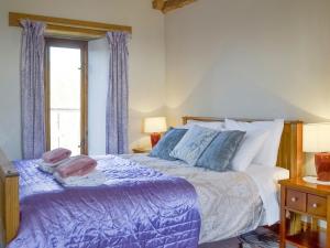 a bedroom with a bed and a window at Foxcote New Court Farm in Marstow