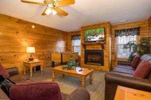 a living room with a couch and a fireplace at Briarstone Lodge Condo 13F in Pigeon Forge