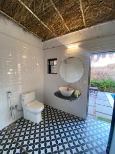 a bathroom with a toilet and a sink in it at GLASS HOUSE with private pool in Lonavla in Lonavala