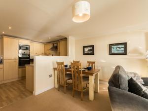 a kitchen and living room with a table and chairs at 13 Great Cliff in Dawlish