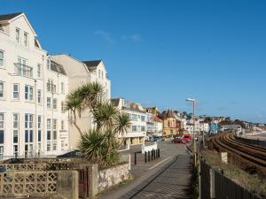 a city street with buildings and a train tracks at 13 Great Cliff in Dawlish