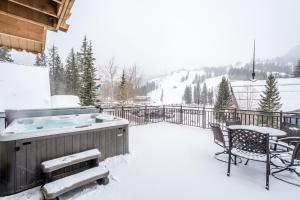 a hot tub on a deck in the snow at Brighton Chalet Utah Entire 9 Bedroom House in Brighton