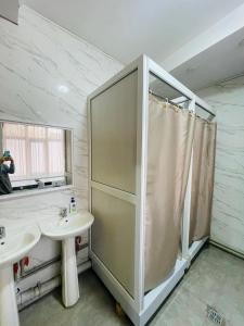 a bathroom with a shower and a sink at Hostel ARBAT in Shymkent +17 photos