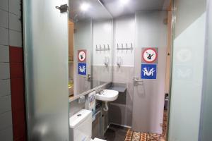 a bathroom with a sink and a toilet and a mirror at Urbany Hostel BCN GO! in Barcelona
