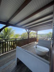 a bath tub sitting on a wooden deck at O'Chalet des îles in Capesterre-Belle-Eau