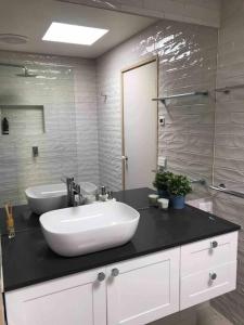 a bathroom with a white sink and a mirror at Beach side Villa in McCrae in McCrae