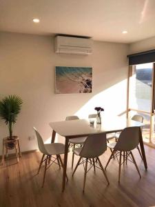 a dining room with a table and chairs at Beach side Villa in McCrae in McCrae