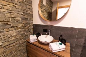 a bathroom with a sink and a mirror at Tiroli in Westendorf