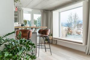 a kitchen with two chairs and a table and a window at QUARTIER 179 in Schladming