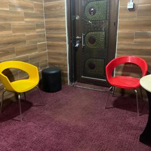 three chairs sitting in front of a door at HPLagos in Lagos