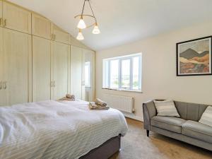 a bedroom with a bed and a couch at Middle Bank Top Farm - Uk39183 in Rossendale