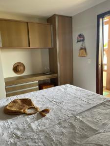 een kamer met een bed met een hoed erop bij Praia do Forte Condomínio Bali Bahia Apt105 in Praia do Forte