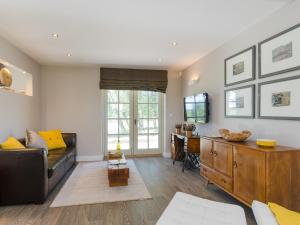 a living room with a couch and a tv at Little Barn in Shirland