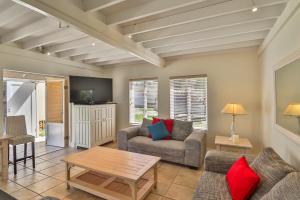 a living room with a couch and a table at 128 @ The Dunes in Plettenberg Bay