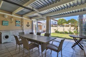 a dining room with a table and chairs on a patio at 128 @ The Dunes in Plettenberg Bay