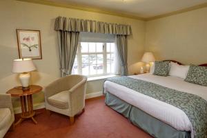 a hotel room with a bed and a window at Old Hunstanton Le Strange Arms Hotel in Hunstanton