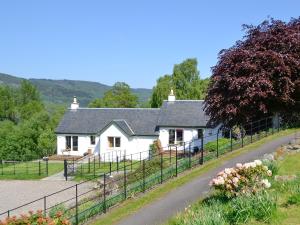 a white house on the side of a road at Farragon Cottage in Foss