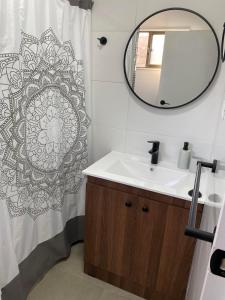 a bathroom with a sink and a mirror at Casa mediterránea Villamar Guanaqueros in Guanaqueros +17 photos